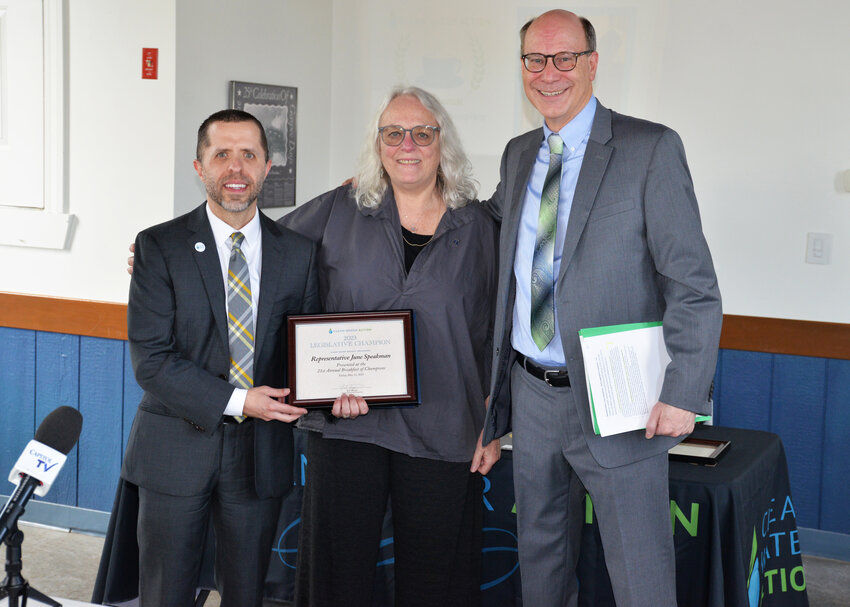 Rep. June S. Speakman, center, receives the Environmental Champion award from Clean Water Action State Director Jed Thorpe, left. Bob Walsh, who emceed the event, is at right.