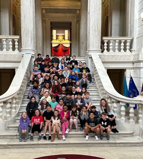 Myron J. Francis 5th Graders recently visited the RI State House. They enjoyed a mock voting session with Rep. Katerine Kazarine (also pictured)