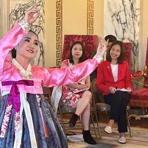 Sen. Linda Ujifusa (right) and Sen. Victoria Gu (center) watch a performance by Korean folk dancer Kate Kim during a celebration of Asian American Pacific Islander Heritage Month at the State House.