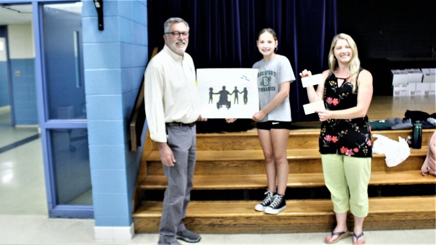 Incoming Lions President Henry Pires and Beckwith Art Teacher Jennifer Faletra presenting Leah with checks for $200.00 for winning this year's award