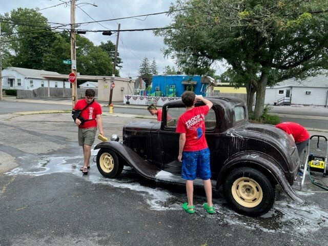 Do you need community service hours? Scouts are always having fun helping in the community. Join us and we will also show you what Scouts are made of. Before the Scouts went to Yawgoog they needed to raise funds to go camping for the week. So they had a car wash to raise the money. In the picture from left to right is Joey Vitolo, Ash Levesque, Jacob Dickstein, and the scout behind the car is Theo Leland. Having fun washing a classic car on a hot day. Thank you to all the Townies and friends that came out to get their cars washed and to help us raise the money we needed to get to Yawgoog