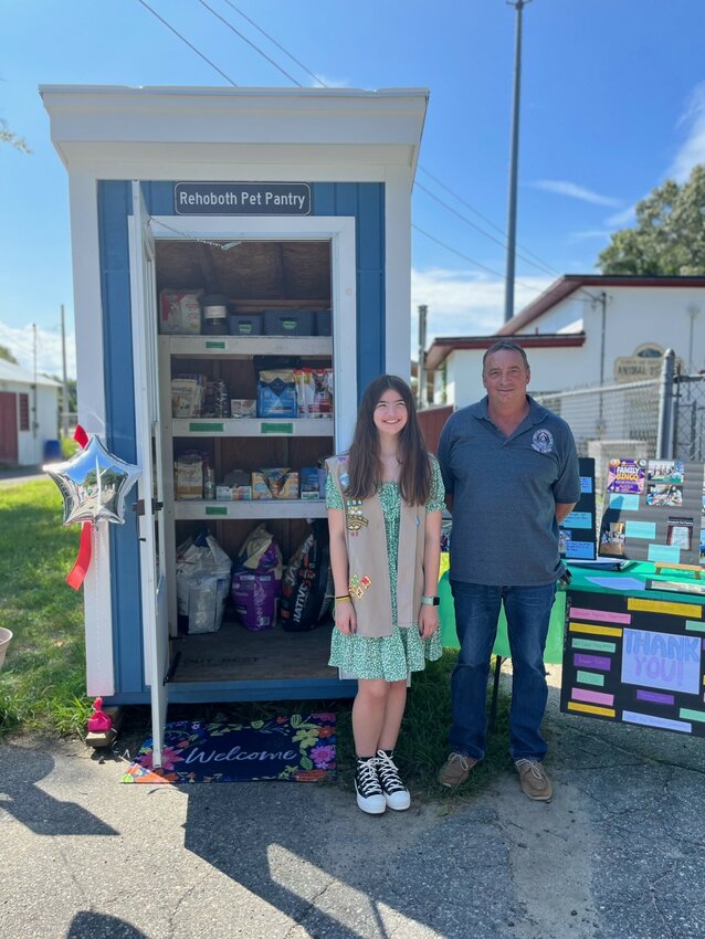 Selectman and Animal Control Officer Rob Johnson and Girl Scout Noelle Blais at the official opening of the Rehoboth Pet Pantry.