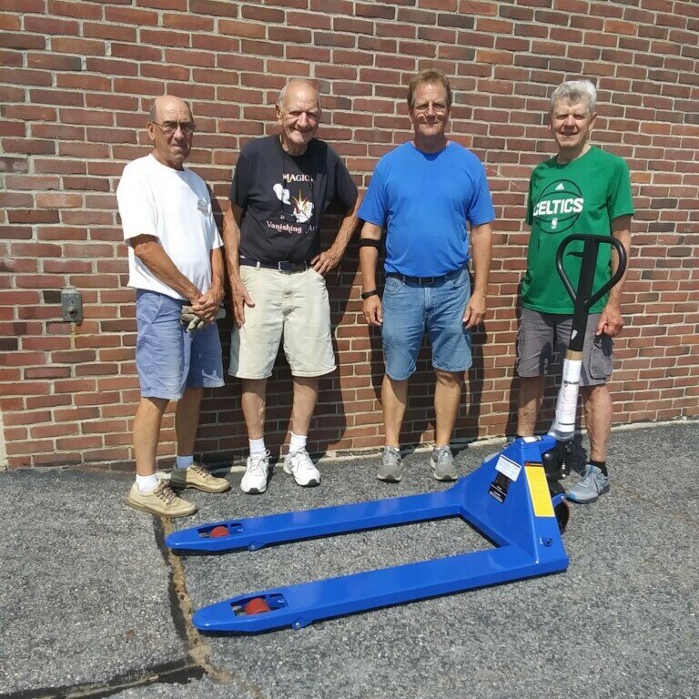 (Pictured L to R: Truck unloaders Marty O&rsquo;Laughlin, Ralph Tomei, Rolland St. Pierre, Robert Karewa)
