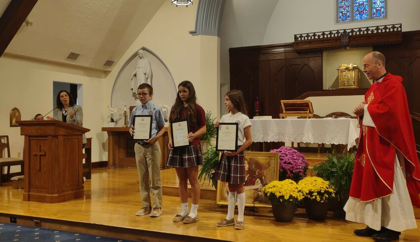 The winners pictured with Principal Nicole Varone and Pastor Father Tim Reilly: l-r Andrew Geiser, Evelyn Fonseca, Emma Olson