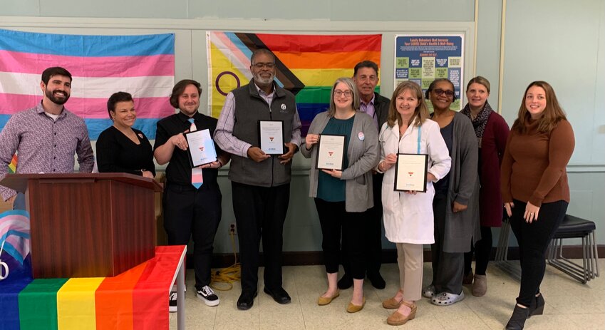 Pictured (L to R): Scott Gowrie, BCBSRI Safe Zone Program Lead; Amy Lagasse, EBCAP&rsquo;s Vice President of Behavioral Health; Quinten Foster, Director of EBCAP&rsquo;s Transgender Whole Healthcare Program; Rilwan K. Feyisitan, Jr., EBCAP&rsquo;s President and CEO; Sarah Reinstein, EBCAP Manager of Quality Initiatives; Robert Crossley, EBCAP&rsquo;s Vice President and Chief Health Administrator; Dr. Lisa Denny, EBCAP&rsquo;s Chief Medical Officer; Annette Richardson, Member of EBCAP&rsquo;s Board of Directors; Kathryn Amalfitano, EBCAP&rsquo;s Vice President of Quality and Performance Improvement; and Marisa Calicchia, BCBSRI Provider Relations Team.