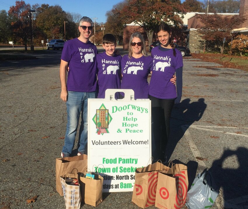 Members of the Baldassi family drop off food collected during the 3rd Annual &ldquo;Hannah&rsquo;s 5K Run for Charity&rdquo;. This is the third year the run has collected food for Doorways.