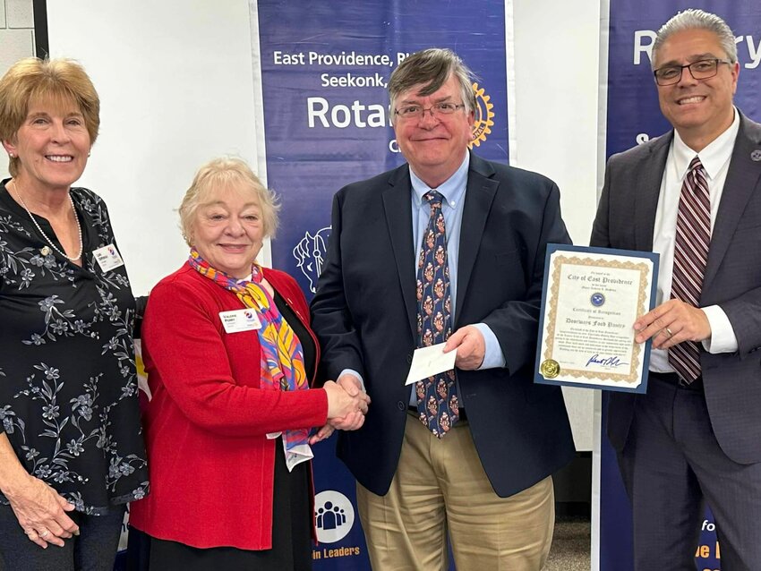 Rotary Co-Presidents Lori DiPersio and Valerie Perry, Gerry McCabe of Doorways, and Mayor Roberto DaSilva of East Providence. The Rotary Club made a donation to combat hunger in our community.