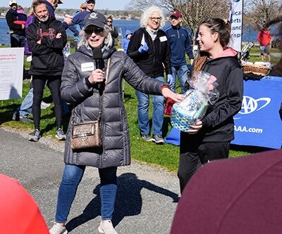 Judianne Point (with microphone) awarding prizes at Pomham Rocks Lighthouse Run