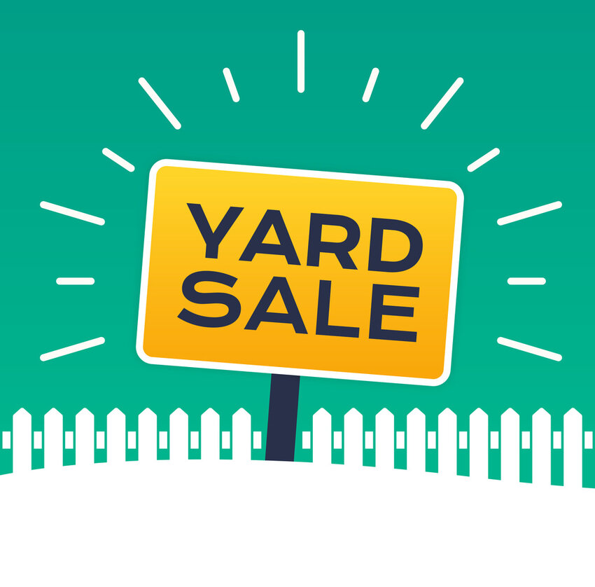 Yard sale sign with white picket fence.
