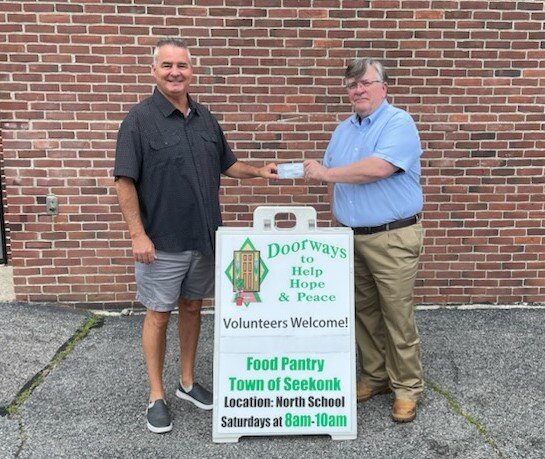 Seekonk Lions President Lenny Silva presents a $5,000.00 check to Gerry McCabe of Doorways Food Pantry to help provide food for our neighbors in need.