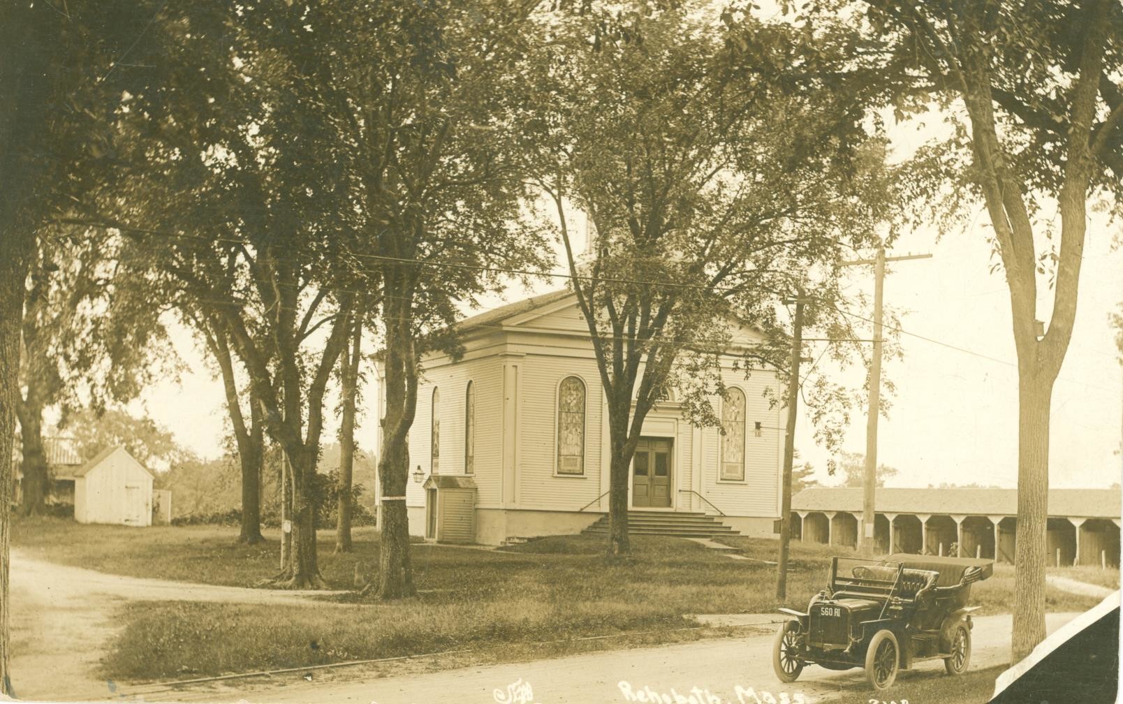 Front view of the Rehoboth Congregational Church circa 1911 with the church carriage shed to the right. The shed was destroyed by the Tornado of 1927, the “Rehoboth Village Twister.” (Postcard postmarked 1911.)
