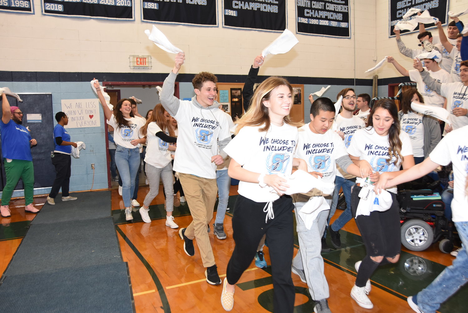 Members of the Unified team run into the gymnasium for the School-wide Assembly.