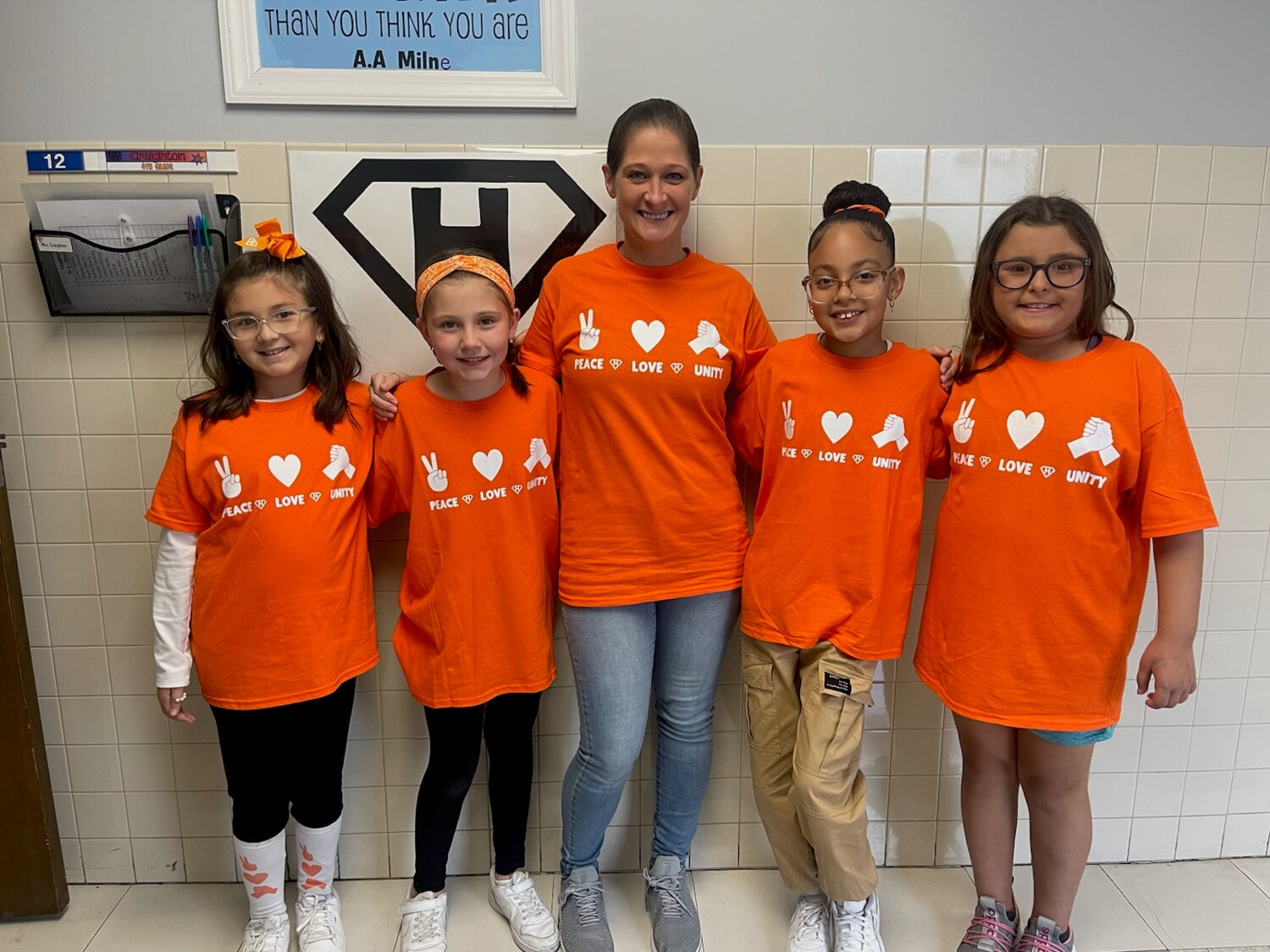 Fourth graders Isabella, Caramia, Jayliana, and Kyley and their teacher, Mrs. Creighton wear matching shirts for Unity Day!