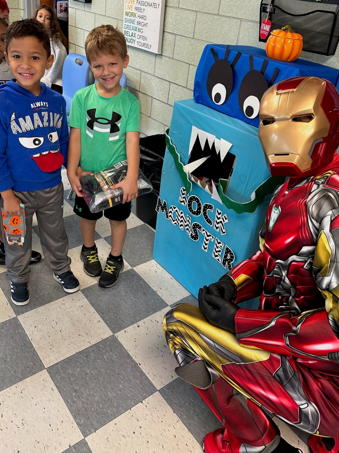 Kindergarten students, Luca and Daniel feed the Sock Monster socks with special guest, Iron Man!