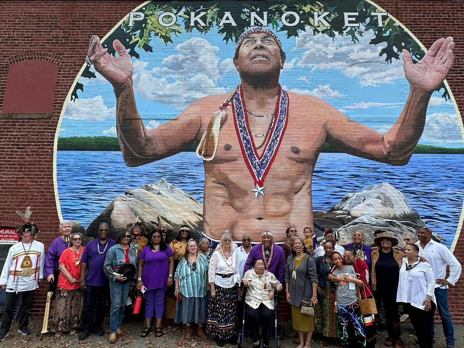 Members of the Pokanoket Tribe attend the unveiling of a mural on October 28 in Watchemoket Square.