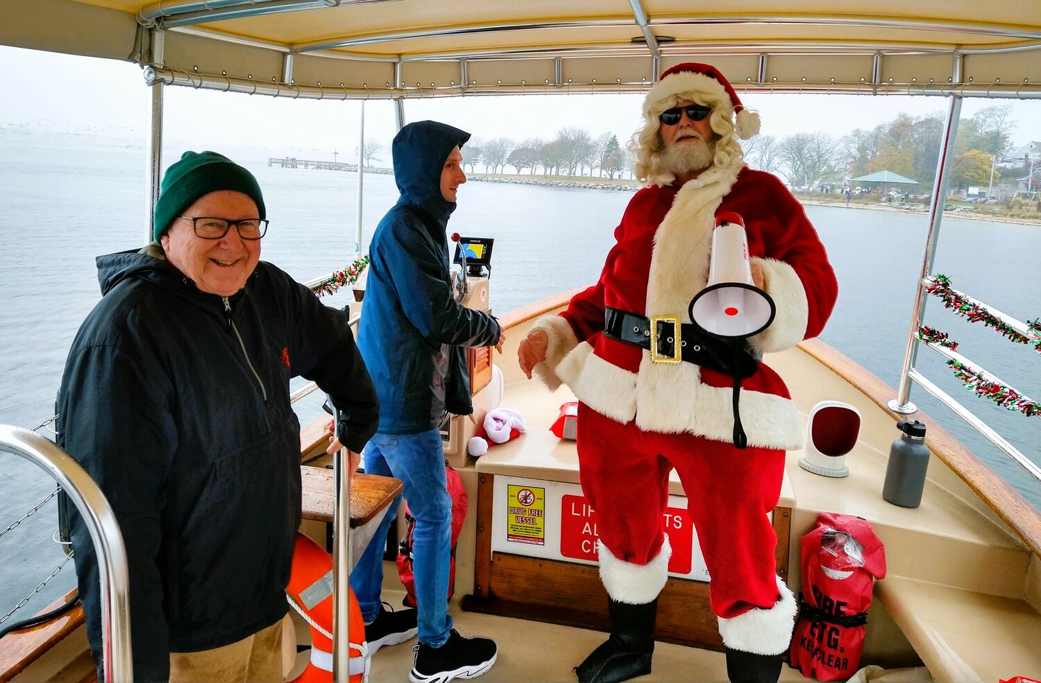 On the Lady Pomham II are, left to right, Dave Kelleher, one of the founders of Friends of Pomham Rocks Lighthouse, Alex Dias, Boat Captain and Vice Chair of the group, and Santa, member Andy Leddy.