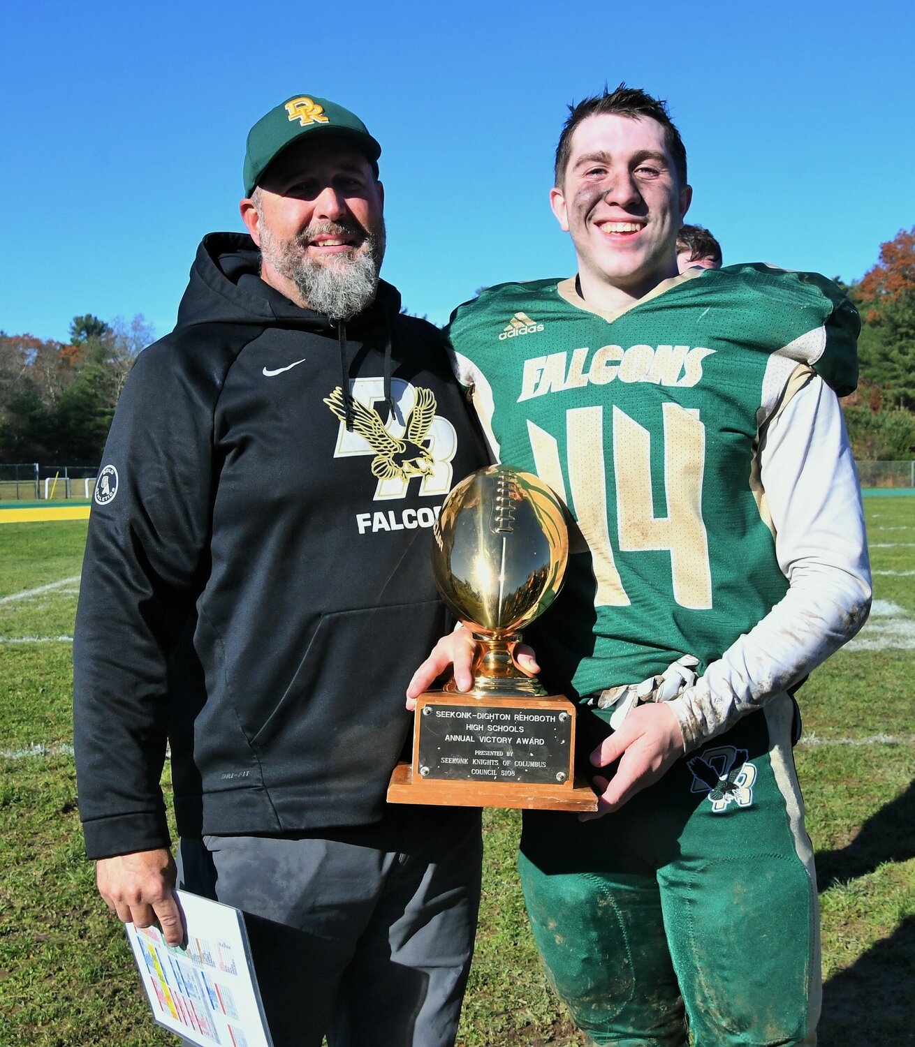 Kevin Gousie, Sr. poses with his son Kevin Gousie, Jr. after winning 42-16 on Thanksgiving.