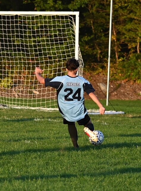 #24: 8th grader Nico Arbelaez shooting a goal at a home game