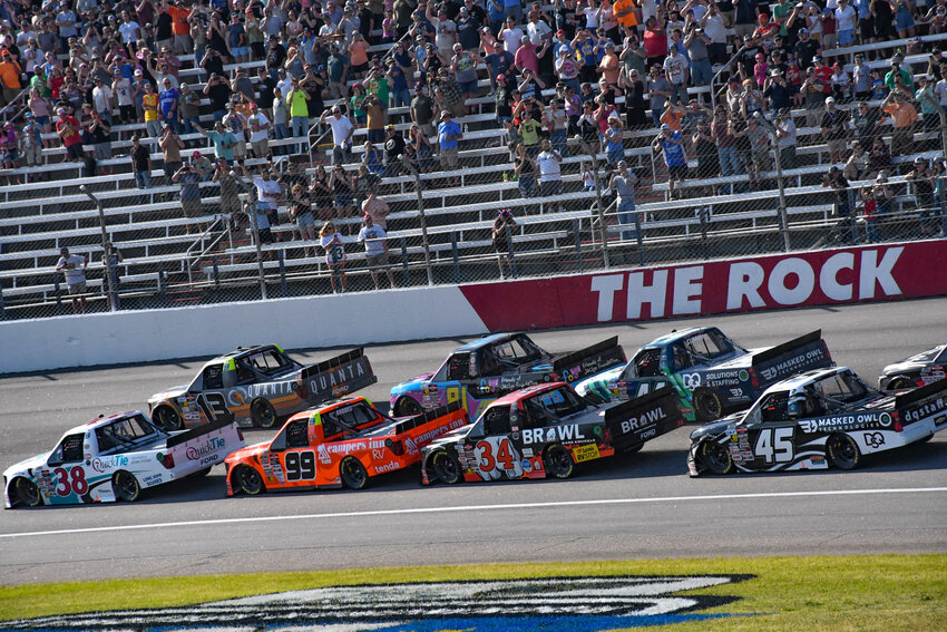 NASCAR Craftsman Truck Series drivers roll down the frontstretch of Rockingham Speedway during the opening laps of the Black's Tire 200.