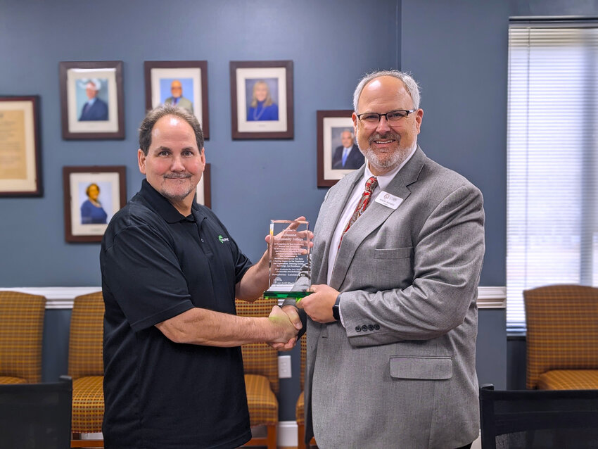 Huvepharma Plant Manager Greg Vance presents Richmond Community College President Brent Barbee a token of appreciation to RichmondCC for the College’s support of the company during its expansion from manufacturing only chicken vaccinations to also including turkey.