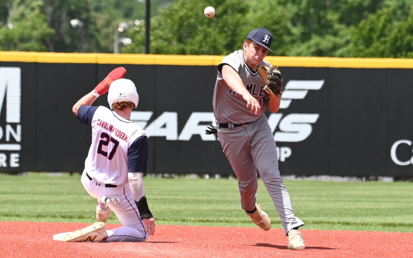 Evan Hodges attempts to turn a double play in Hamlet's first game of the season Sunday.