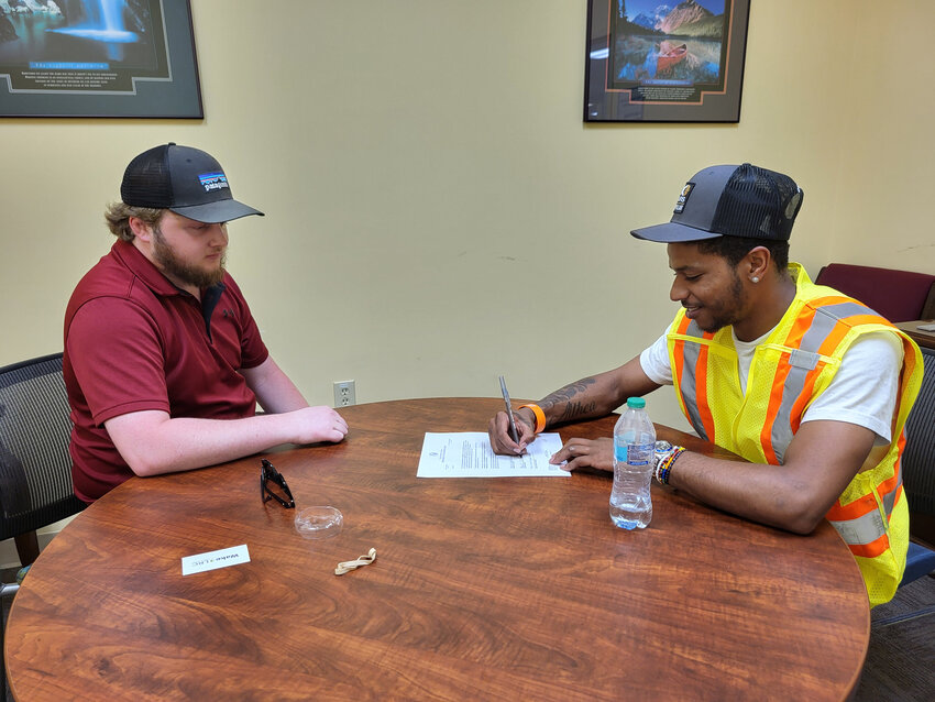 Jahwon Hartsfield (right) was recently hired as a transportation worker by the N.C. Department of Transportation. Hartsfield was one of five formerly incarcerated people to complete a highway construction work training academy.
