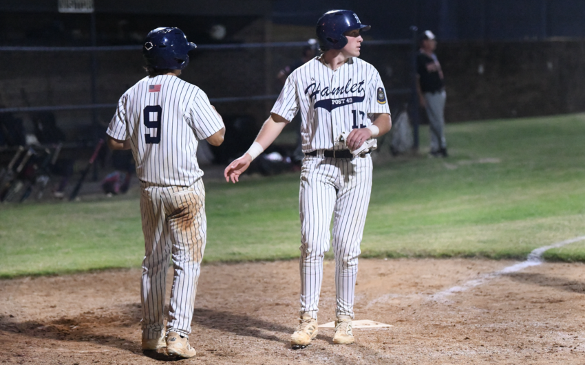 Caden Nolan (13), who had 4 RBI in Monday's game, scores and high-fives teammate Drew Gause (9) during Hamlet's five-...