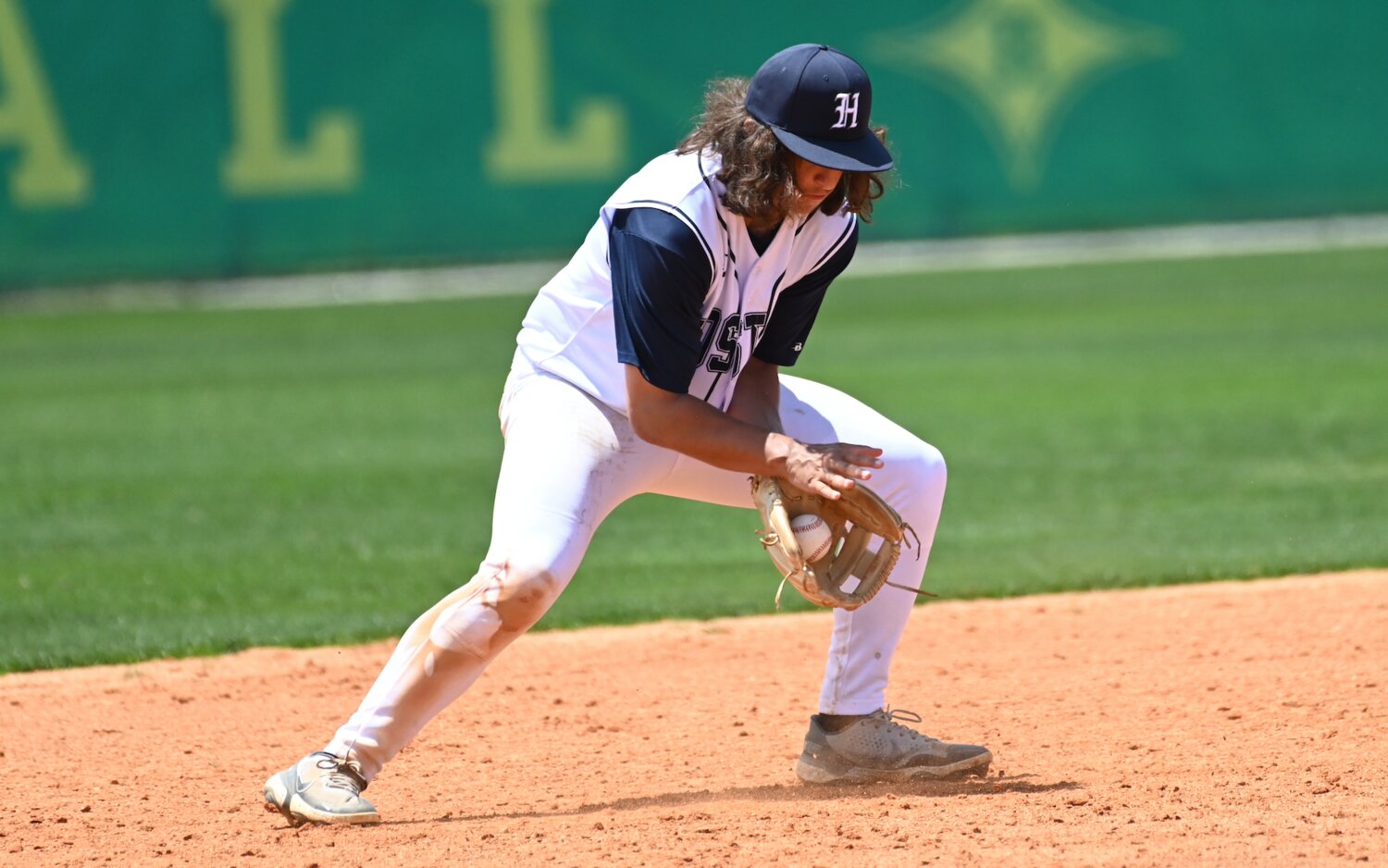 Drew Gause, who had a double in Saturday's season opener, fields a ground ball at third base for an out.