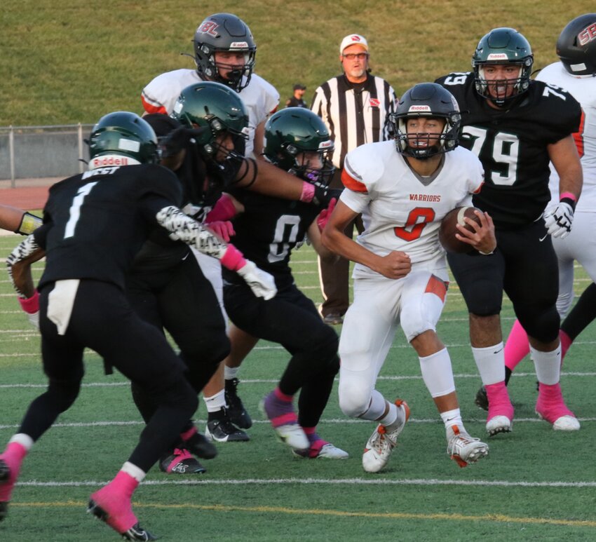 On his way to paydirt, QB Isaiah Jervik (8) eludes a host of tacklers.