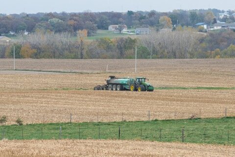 Spreading manure in field.