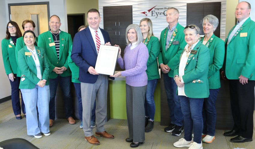 Dr. Benjamin Uhl (left, front) of Sergeant Bluff EyeCare, received the Veteran-Owned Small Business Award from U.S. Sen. Joni Ernst (R-IA.) (right, front) in a special ceremony held Saturday (Mar. 8) at the SB-EyeCare Clinic. A packed crowd, inclusive of the Sioux City Chamber of Commerce, were on hand at the gathering. Sen. Ernst is the ranking member of the U.S. Small Business Committee. (Photo: SBA)