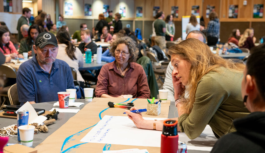 Katie Riley, deputy director of policy and programming at Sitka Conservation Society, writes on butcher paper this morning during the Sustainable Southeast Partnership Spring Retreat at Harrigan Centennial Hall. This was the final day of the three-day program organized by Juneau-based  Spruce Root Community Development organization. Spruce Root offers business loans and business advisory services to Southeast businesses.