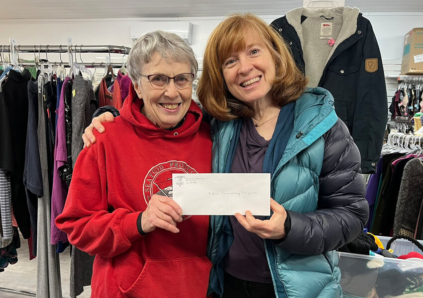 GRANT AWARD – White Elephant Board secretary and volunteer Sue Fleming, left, presents a $2,000 grant award to Jeanine Brooks, Sitka School District social worker. (Photo provided to the Sentinel)