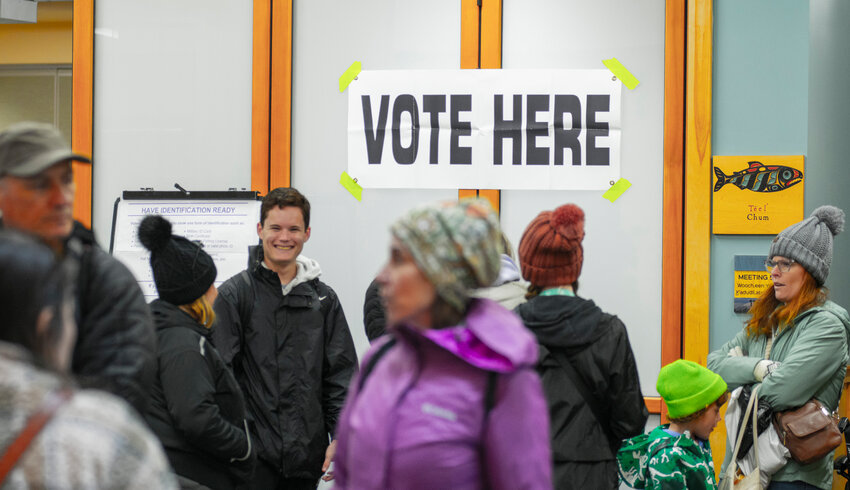 Tourists and locals walk through the lobby at Harrigan Centennial Hall recently in front of a room dedicated to early voting. On average each day 150 people have been casting votes in the election to decide on a ballot initiative to limit the number of cruise ships visiting Sitka. The regular election is slated for May 28.