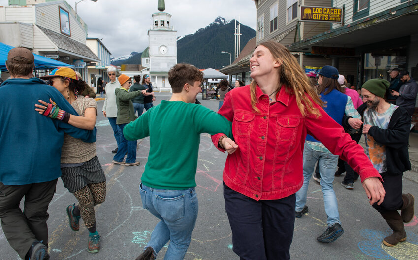 Maia Carter, facing camera, and other Sitkans dance on Lincoln Street during the 2024 Sitka Porch Fest. Carter is coordinating music for this year's festival, which takes place Saturday.