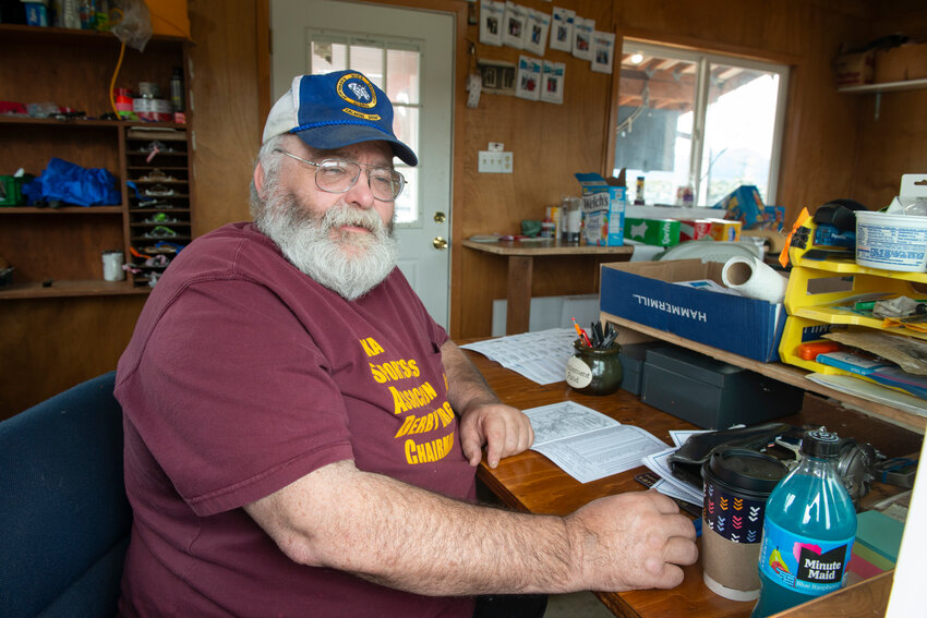 John McCrehin works the counter at the Sitka Sportsman's Association Salmon Derby weigh-in barge at Crescent Harbor today.