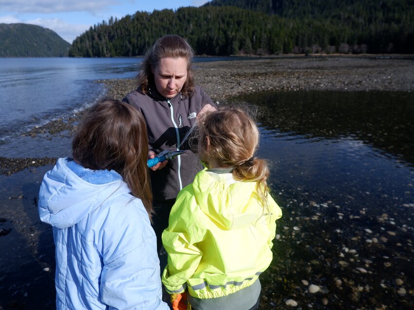Instructor Nicole Filipik shows kids how to take water measurements in the ocean near Sitka as part of the 4-H pH program this spring. (Photo provided by Jasmine Shaw)