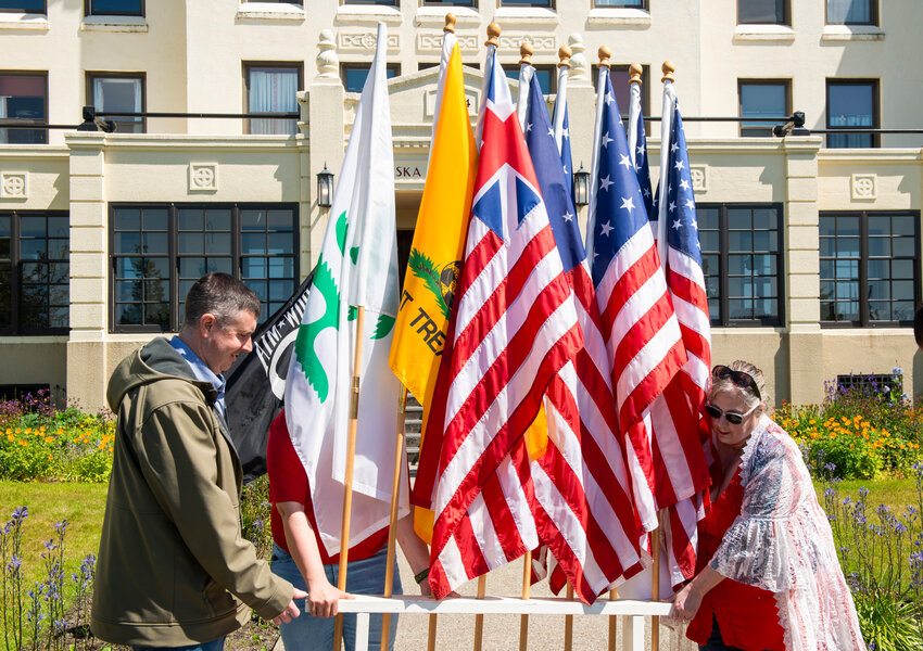 Sitka Elks Club Exalted Ruler John Leach, left, and Chaplain Mindy Lowrence, who is also the president of the Sitka Emblem Club, set out flags in front of the Pioneers Home Saturday afternoon in preparation for a Flag Day ceremony. The annual June 14 celebration honors the history of the American flag. It is also an opportunity for people to properly disposed of their worn-out flags. A parade with the club's giant garrison flag was cancelled in order to avoid being perceived as a political statement.