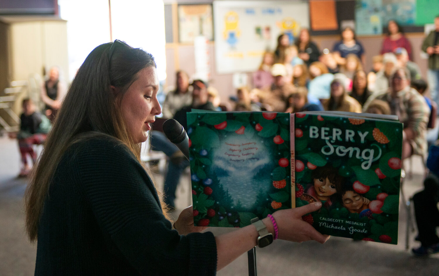 Michaela Goade,  a Caldecott medalist and New York Times bestseller for her illustrations, reads from her 2022 book, Berry Song, at Keet Gooshi Heen Elementary School May 6. Goade told the audience this was the first children's book she both illustrated and wrote. In her presentation, which was attended by about 100 children and adults, she discussed the process of writing and creating paintings for publication.  The event included a game of Berry Bingo, a QR Code walk, Sitka Swirls ice cream and Goade led a watercolor workshop.