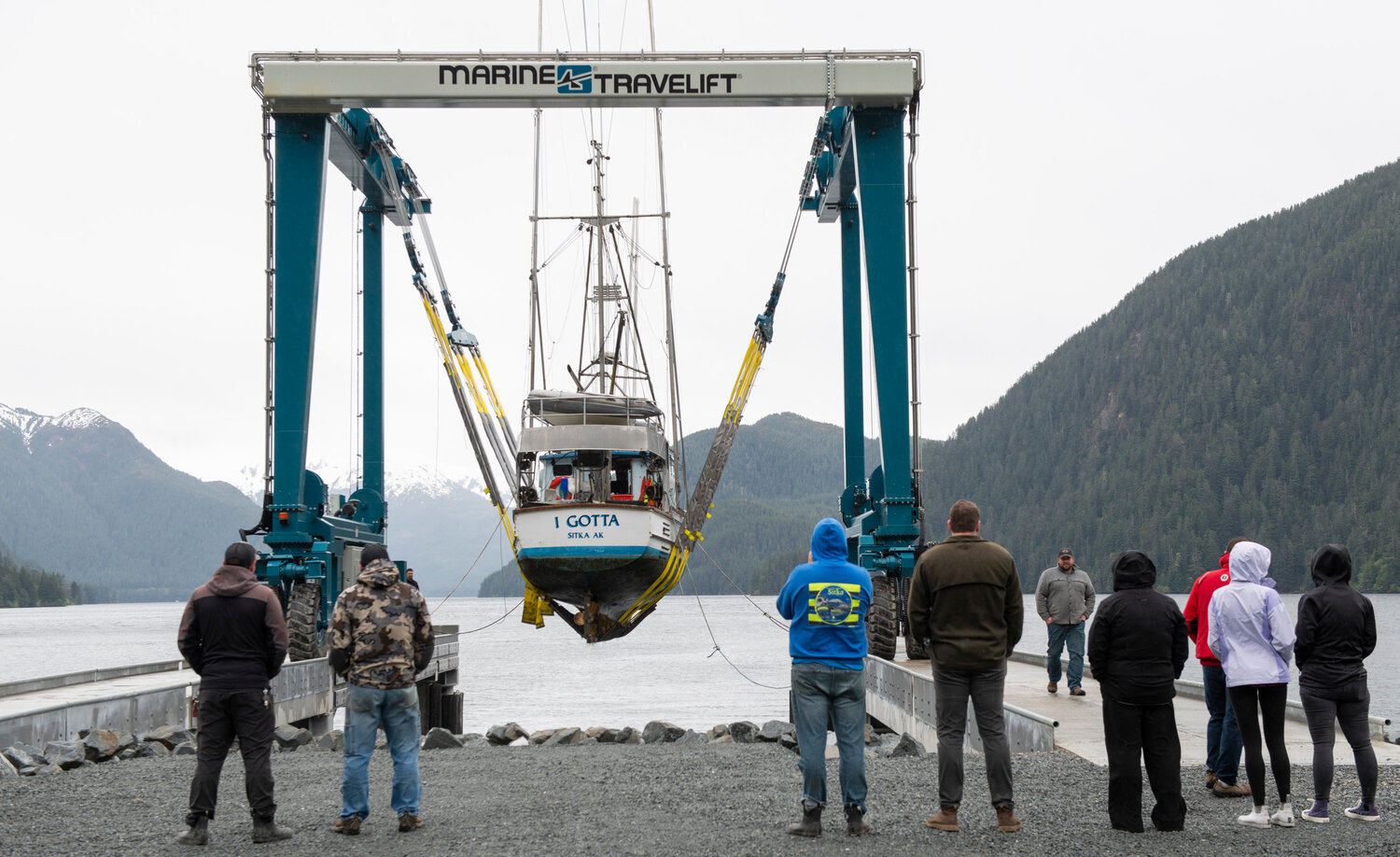 About a dozen Sitkans watch as the first boat is hauled out of Silver Bay at the new city haulout facility in the Gary Paxton Industrial Park Thursday afternoon. Sitka fisherman Eric Jordan was eager to have his troller, the F/V I Gotta, be the first one to use the facility that was mostly paid for using funds from the city's sale of the community hospital property to SEARHC.