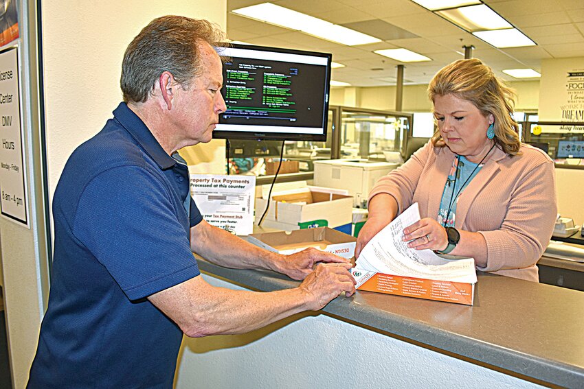 Benton County taxpayer Mike Lewandowski watches as auditor-treasurer Christine Scherbing examines a box containing a reverse referendum petition May 29 inside the Benton County Government Center in Foley. Montgomery Headley, county administrator, reported during a June 3 board meeting the petition contained 1,147 valid signatures, forcing an election to determine the fate of $29.7 million in proposed bonding for a new county government center in Foley.