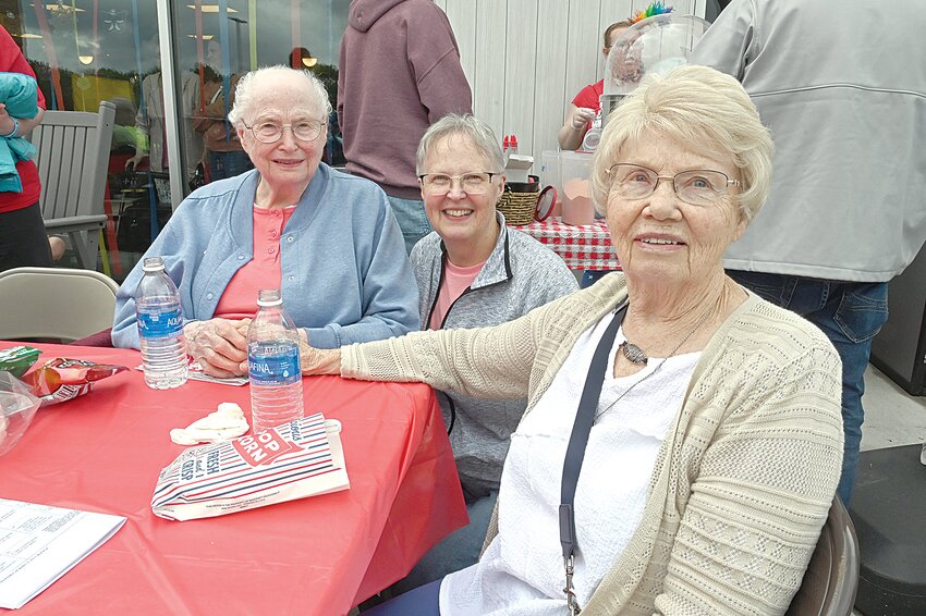 Irene Wallin (from left), Jean Quistorff and Mary Jennissen smile as they have lunch together during a community picnic June 6 at Cura of Sauk Centre care center in Sauk Centre. Picnic guests were welcomed with sandwiches, beverages, popcorn, cotton candy and entertainment at the carnival-themed event.