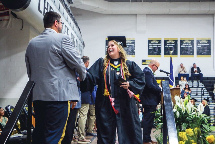 Edith Deubner exits the stage with diploma in hand.