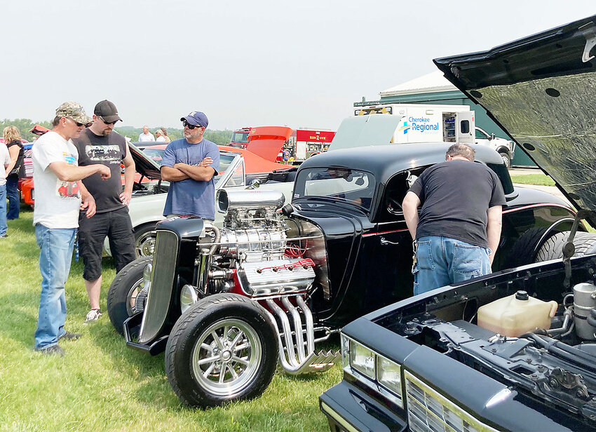 Matt Fredericksen, third from left, fields questions at the Flight Breakfast car show in Cherokee.