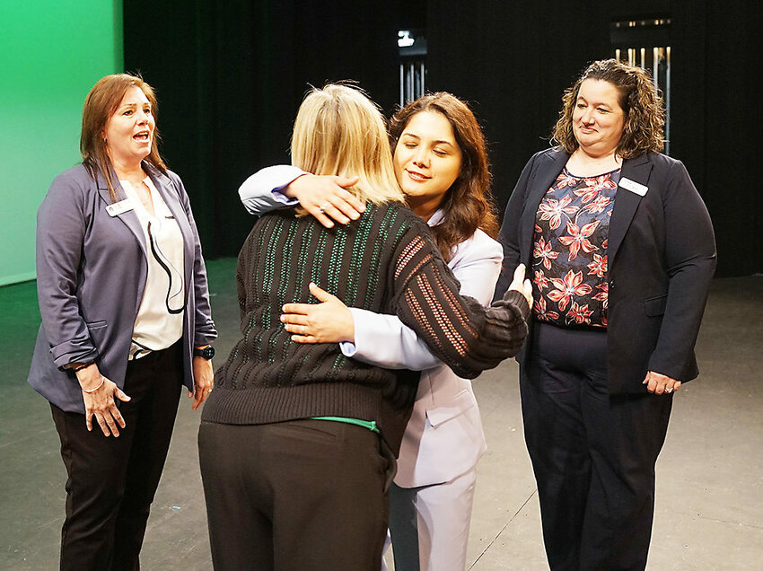 Dr. Stacey Cole has a hug for Maryam Rod Szabo of the Iowa Department of Education, with whom she’s worked to coordinate the apprenticeship program. Also from DEI are Dr. Stephanie TeKippe, left, and Amy Mayer, right.