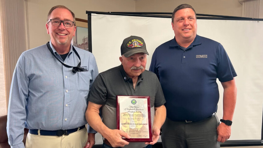 David Hintz, left, and Jason Glass, right, from the FAA with Jim Bartholomew, center.