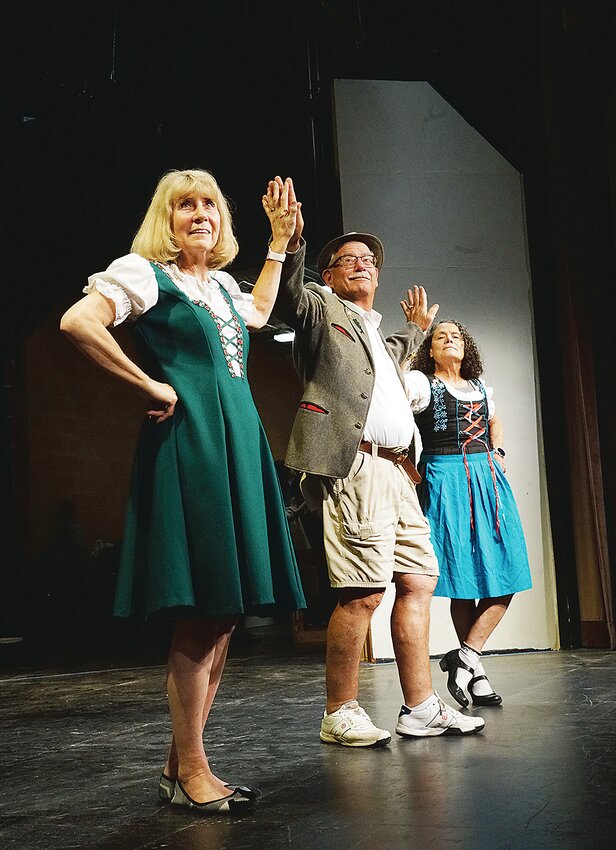 Ready for the German National Anthem are, from left: Jacquelyn Courtright, Dave Zelle and Deb Hankens, all of Cherokee.