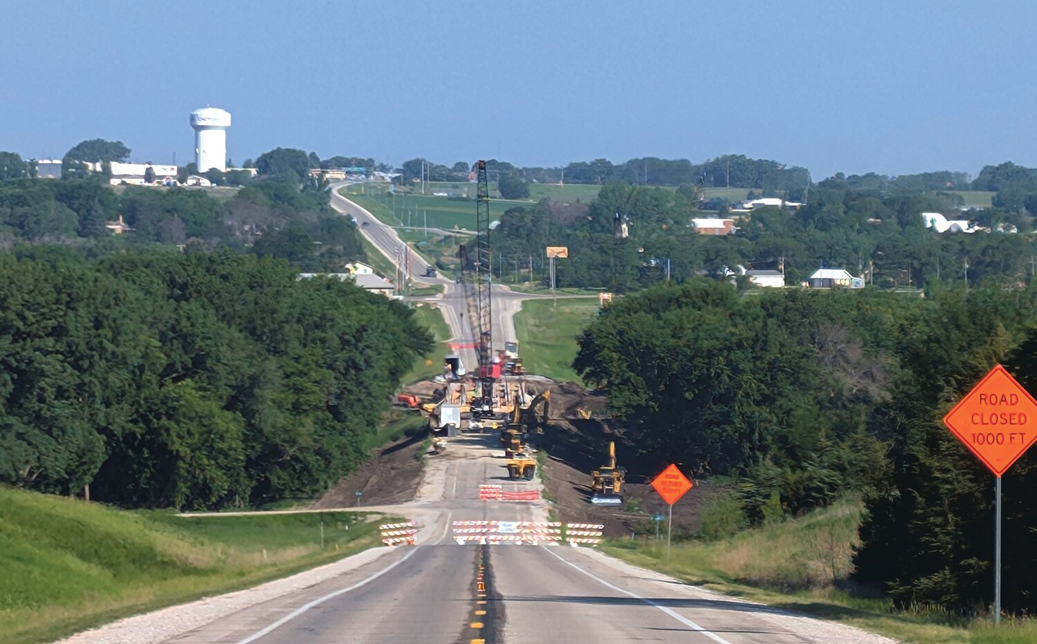 Crews with the Iowa Department of Transportation's contractor working on Wednesday morning replacing the 320-by-30 foot bridge between Highway 59 and C38. The bridge is expected to rise five feet from its original height over the Little Sioux River, a design that flowed from historic flooding along the Little Sioux last summer. The $12.8 million project is expected to be complete by November.