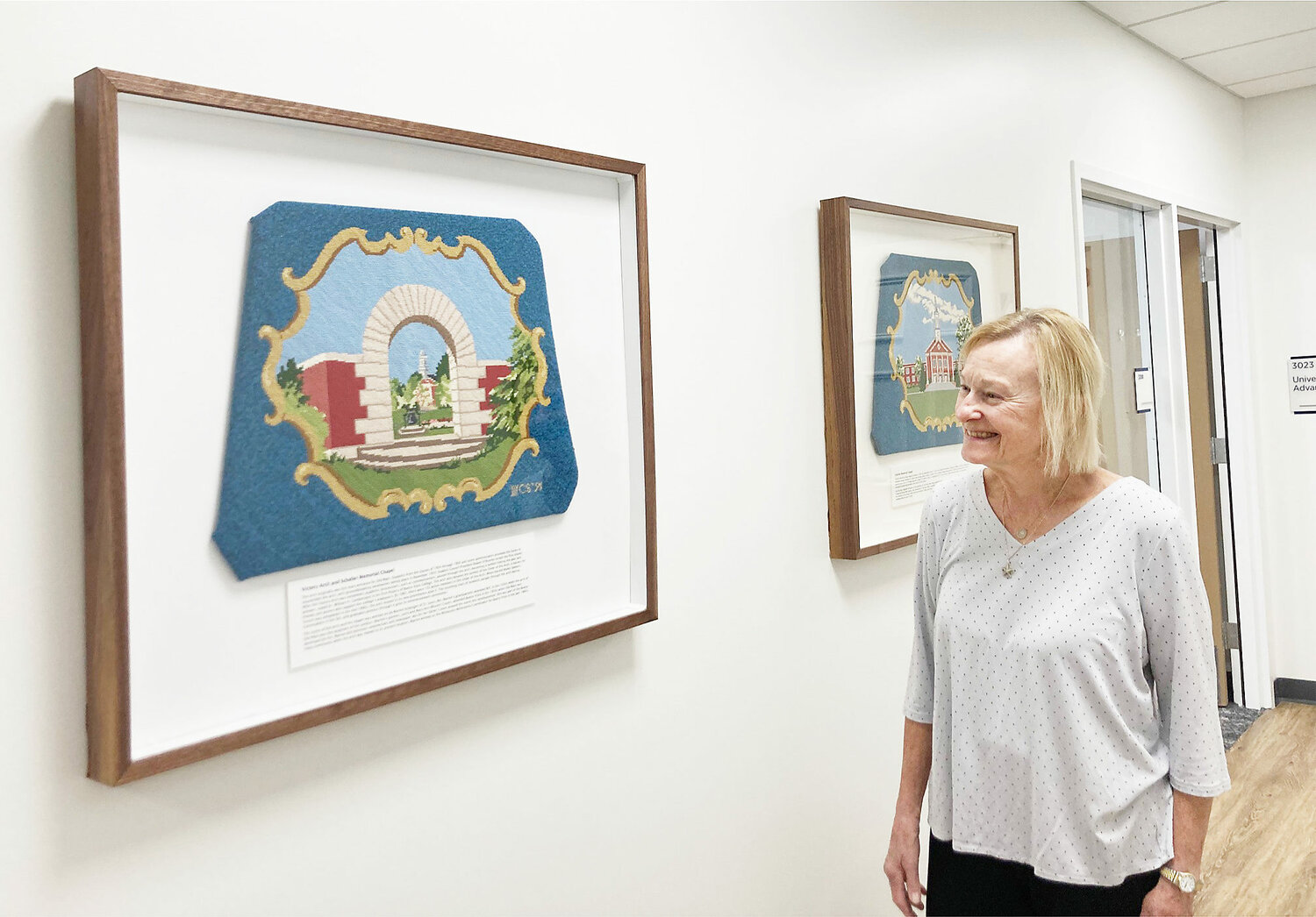 Barb Dvergsten admires a needlepoint chair cover of the Victory Arch and Schaller Memorial Chapel. Ballou Library (now the president’s office) was named after Barb’s grandfather L.E. Ballou. Her father E.L. Ballou was a trustee.
