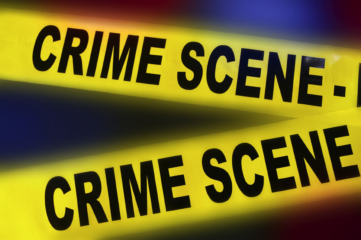 50928053 - yellow police crime scene tape on red and blue background